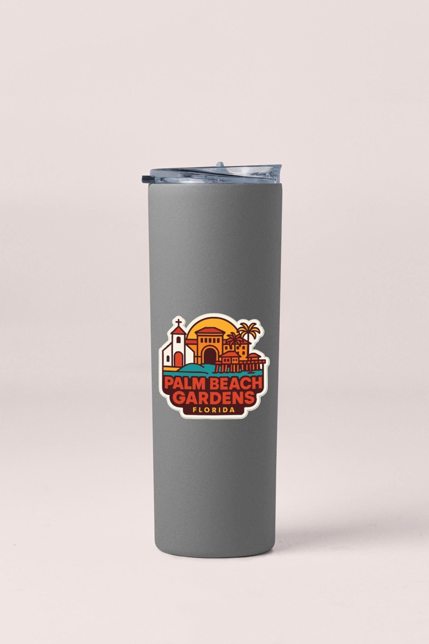 A gray insulated tumbler with a logo for Palm Beach Gardens, Florida, featuring an illustration of the city's landmarks and buildings.