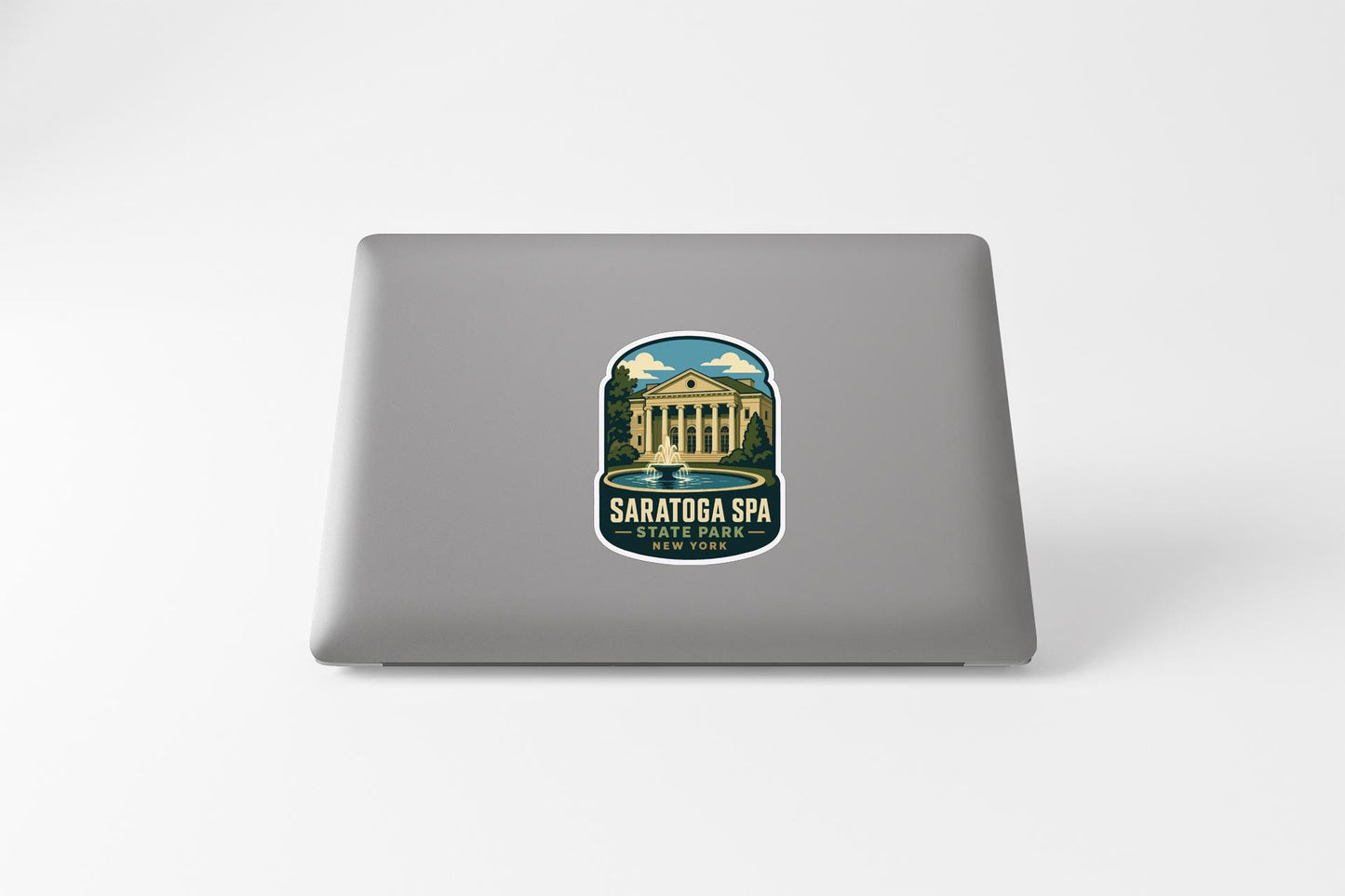 a sticker on the back of a laptop, depicting a building with columns and a fountain.