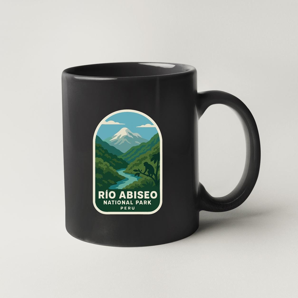 A black coffee mug with a label that says "Rio Abisito National Park Peru".