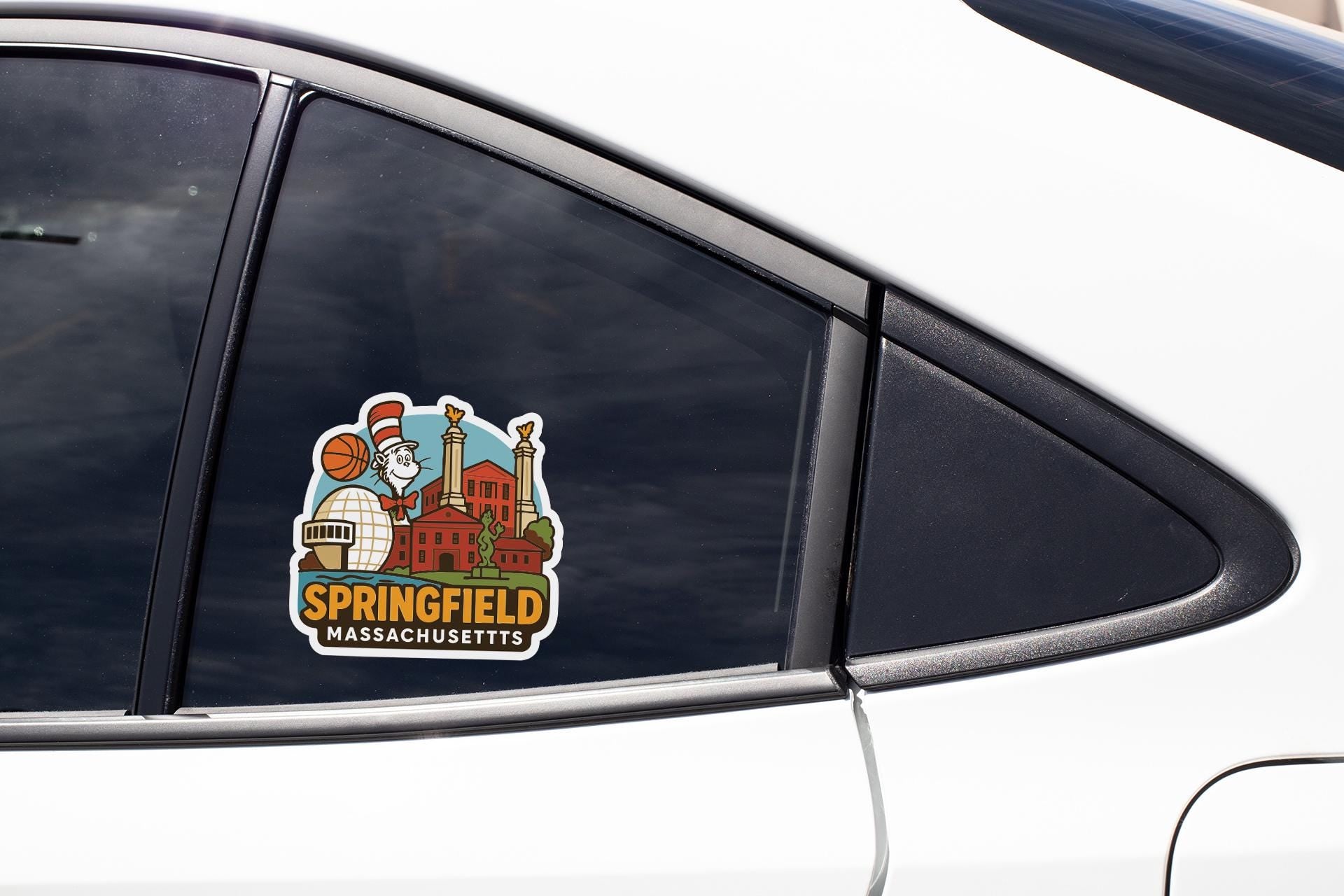 A sticker on the side of a car window, depicting a city skyline with a basketball player and the text "Springfield, Massachusetts".