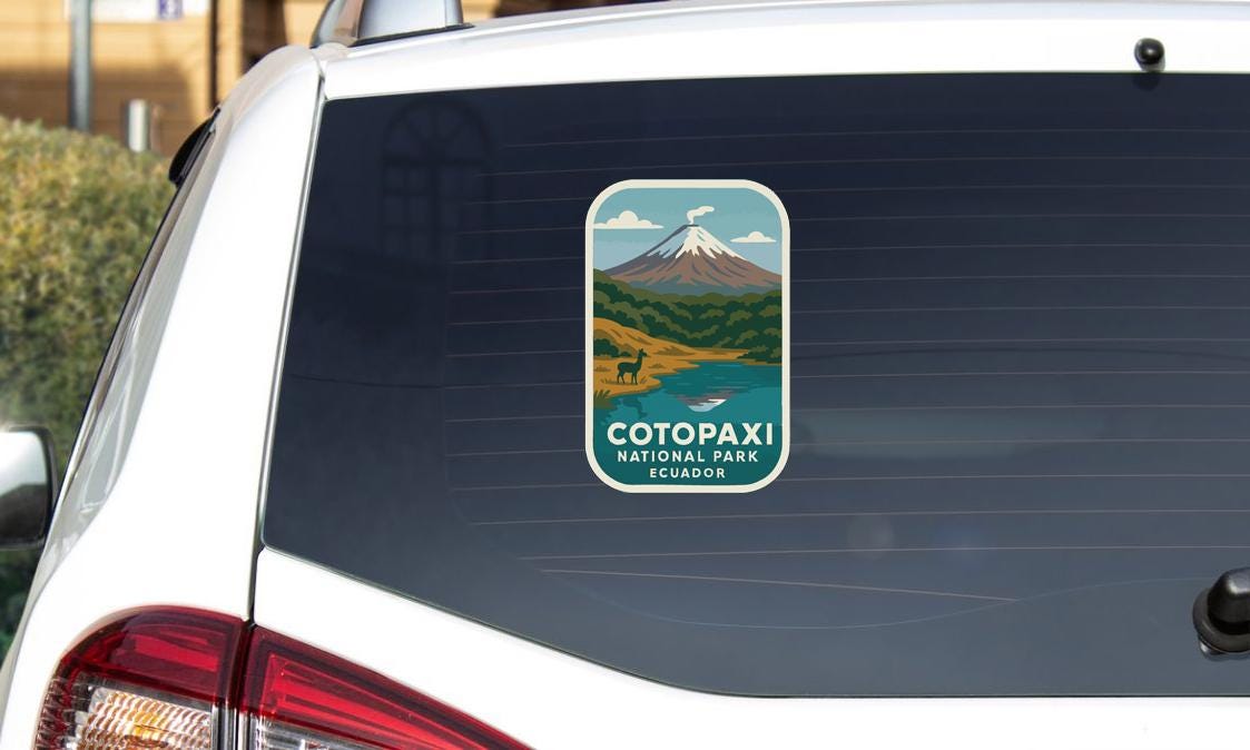 A sticker on the rear window of a white car, depicting a mountain landscape with a snow-capped peak and a river flowing through the valley.