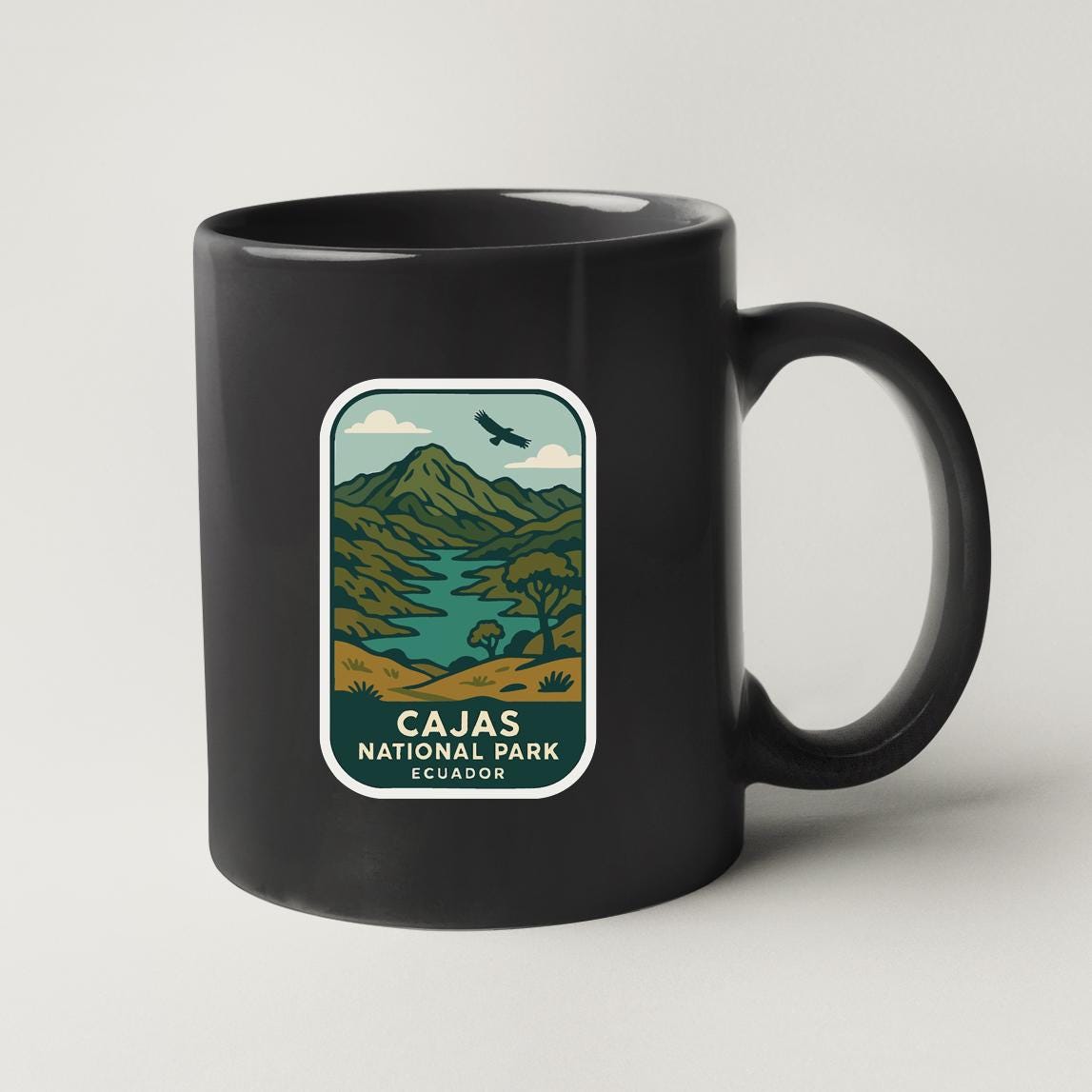 A black coffee mug with a label that says "Cajas National Park Ecuador".