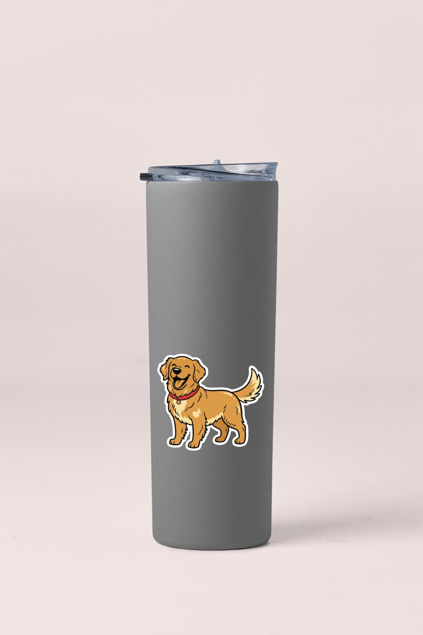A gray insulated tumbler with a sticker of a cartoon dog on it.