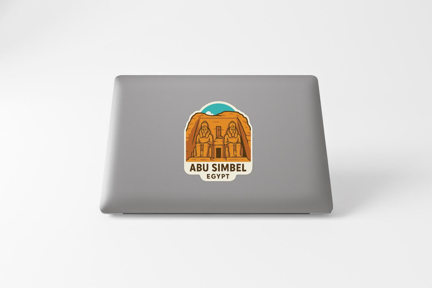 a sticker or decal on the back of a laptop, depicting the Abu Simbel temple in Egypt.