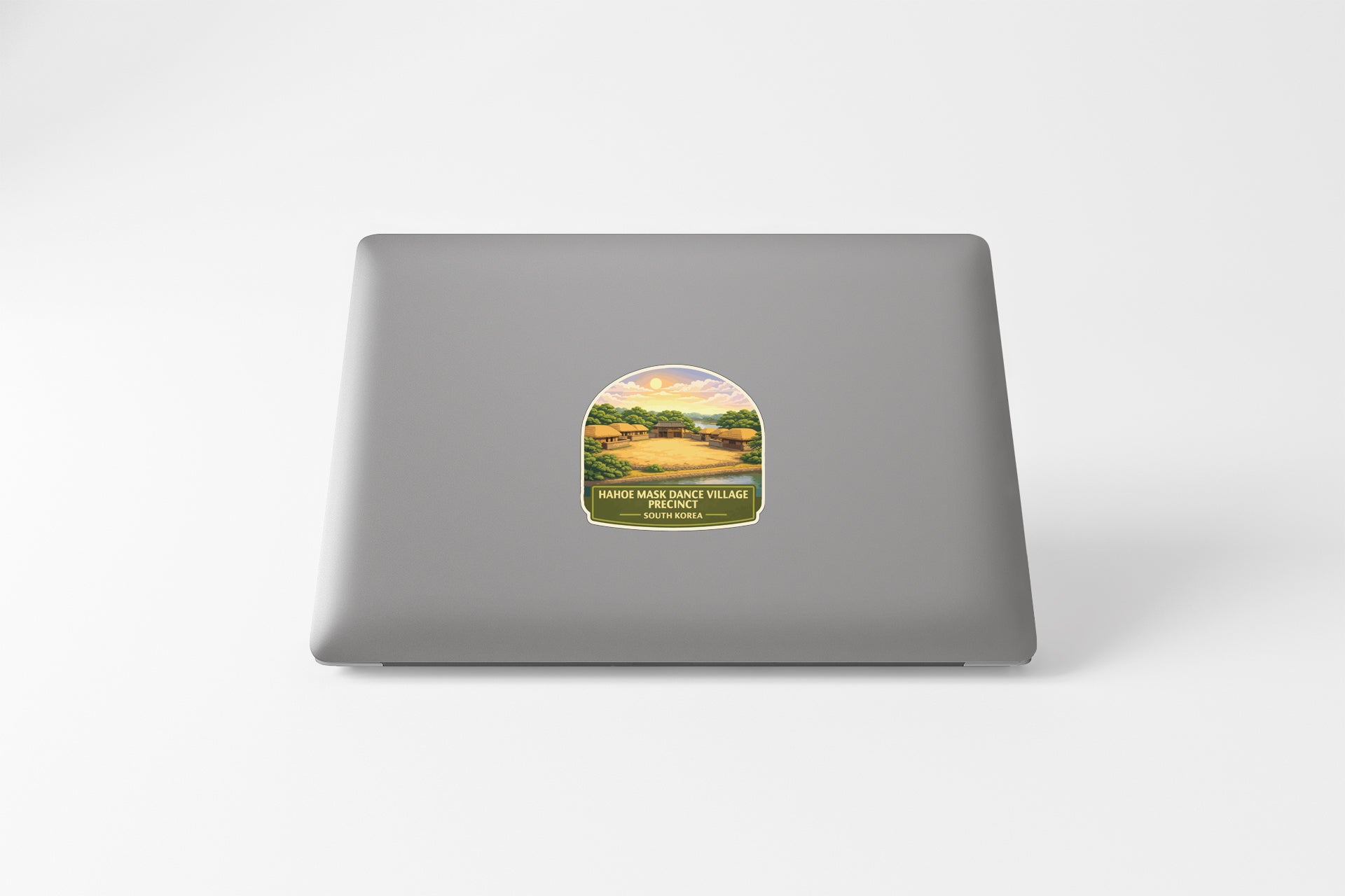 A sticker with a landscape image on a laptop.