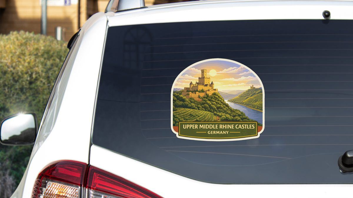 A sticker on the rear window of a car depicting a castle on a hill with a river in the background.