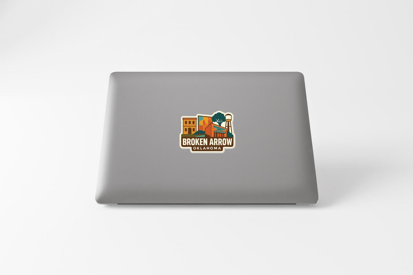 a sticker on the back of a laptop that says "Broken Arrow Oklahoma".