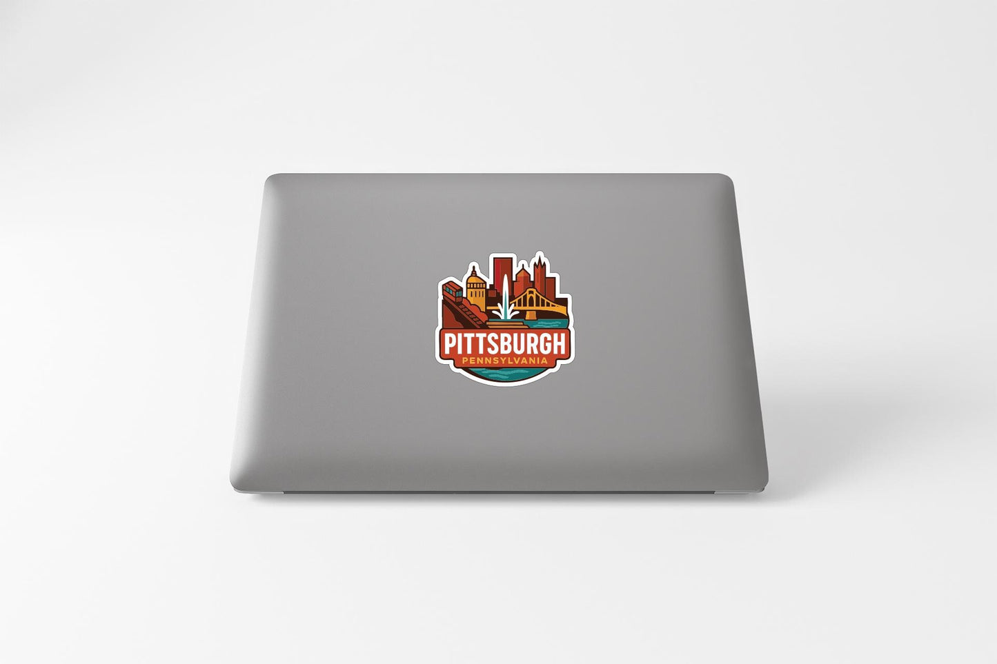 A sticker with the Pittsburgh logo on the back of a laptop computer.