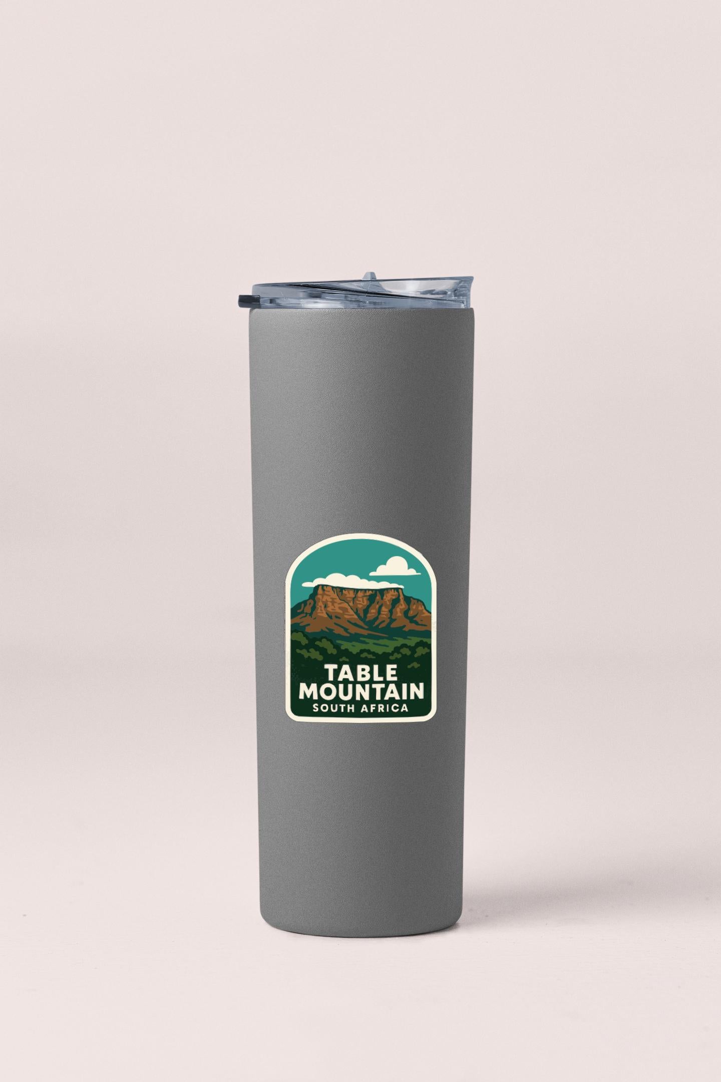 A gray insulated tumbler with a mountain landscape sticker on it.