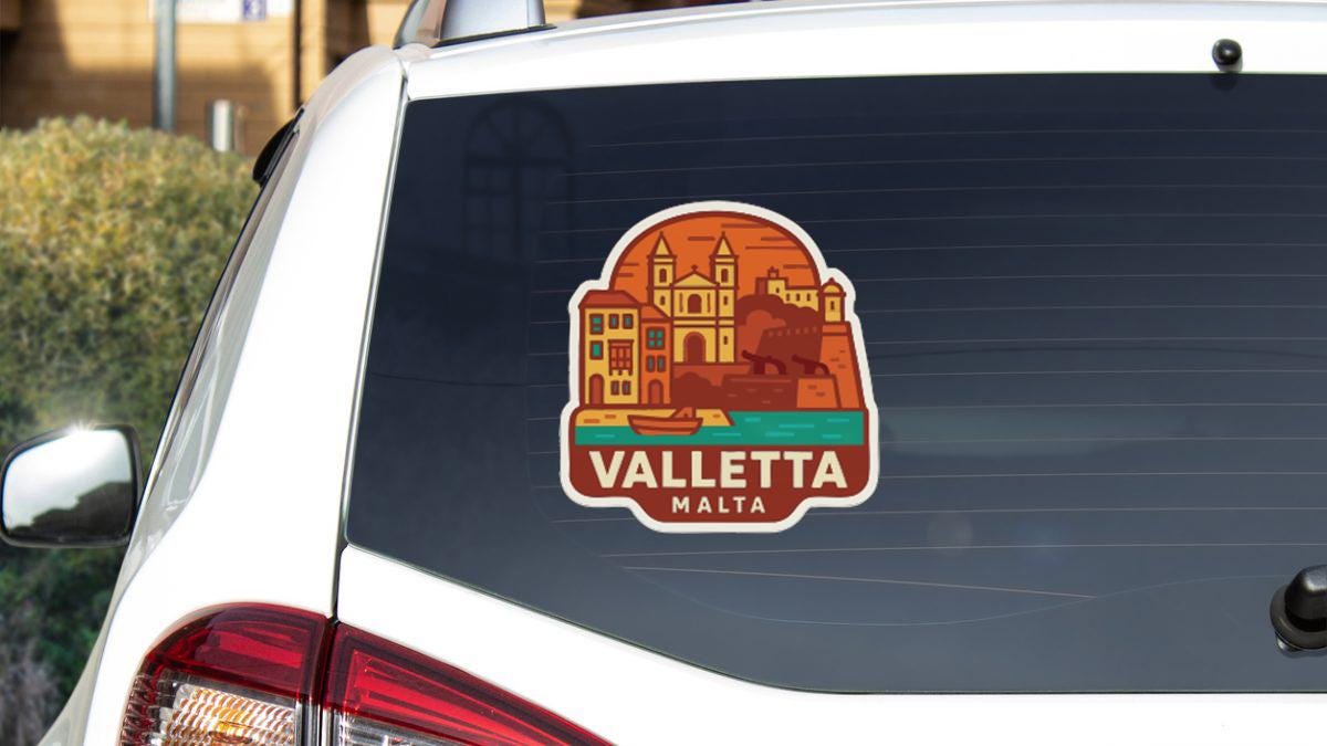 A sticker on the rear window of a car that features an illustration of Valletta, Malta.