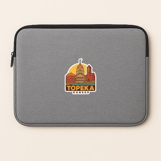 A gray laptop sleeve with a graphic of the state of Kansas and the text "TOPEKA KANSAS" printed on it.