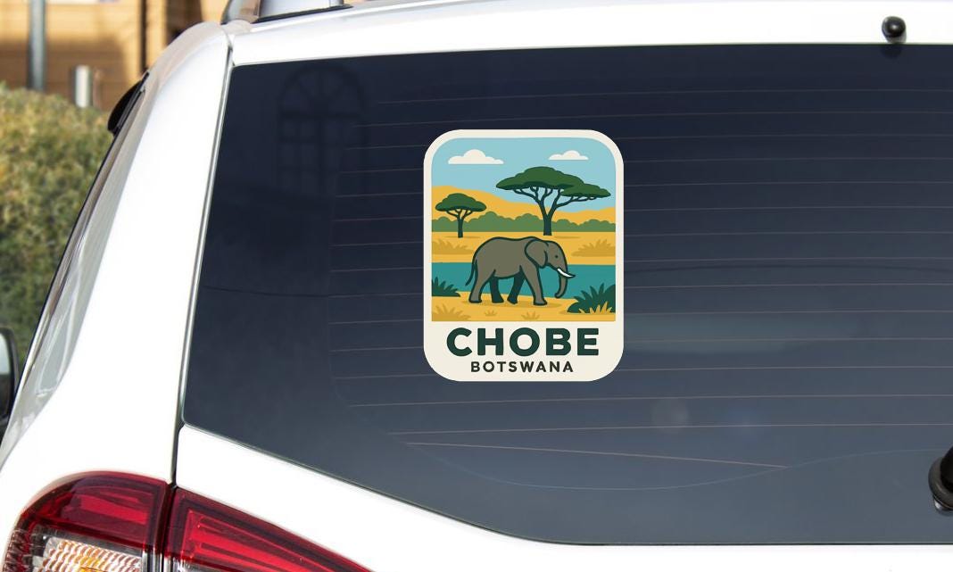 a sticker on the rear window of a car, depicting an elephant in a natural setting.