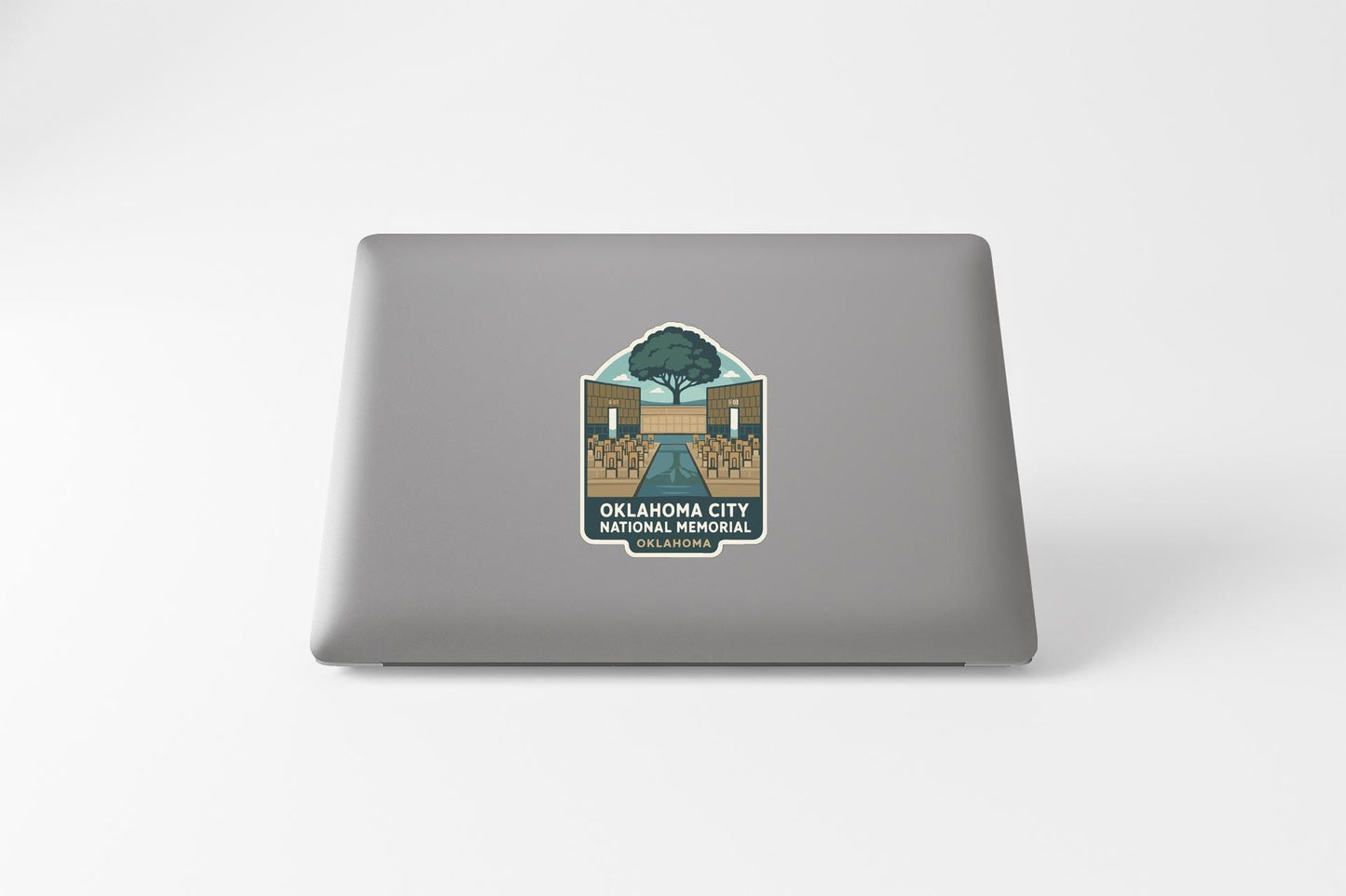 a sticker on the back of a laptop, depicting a scenic view of Oklahoma City National Memorial.