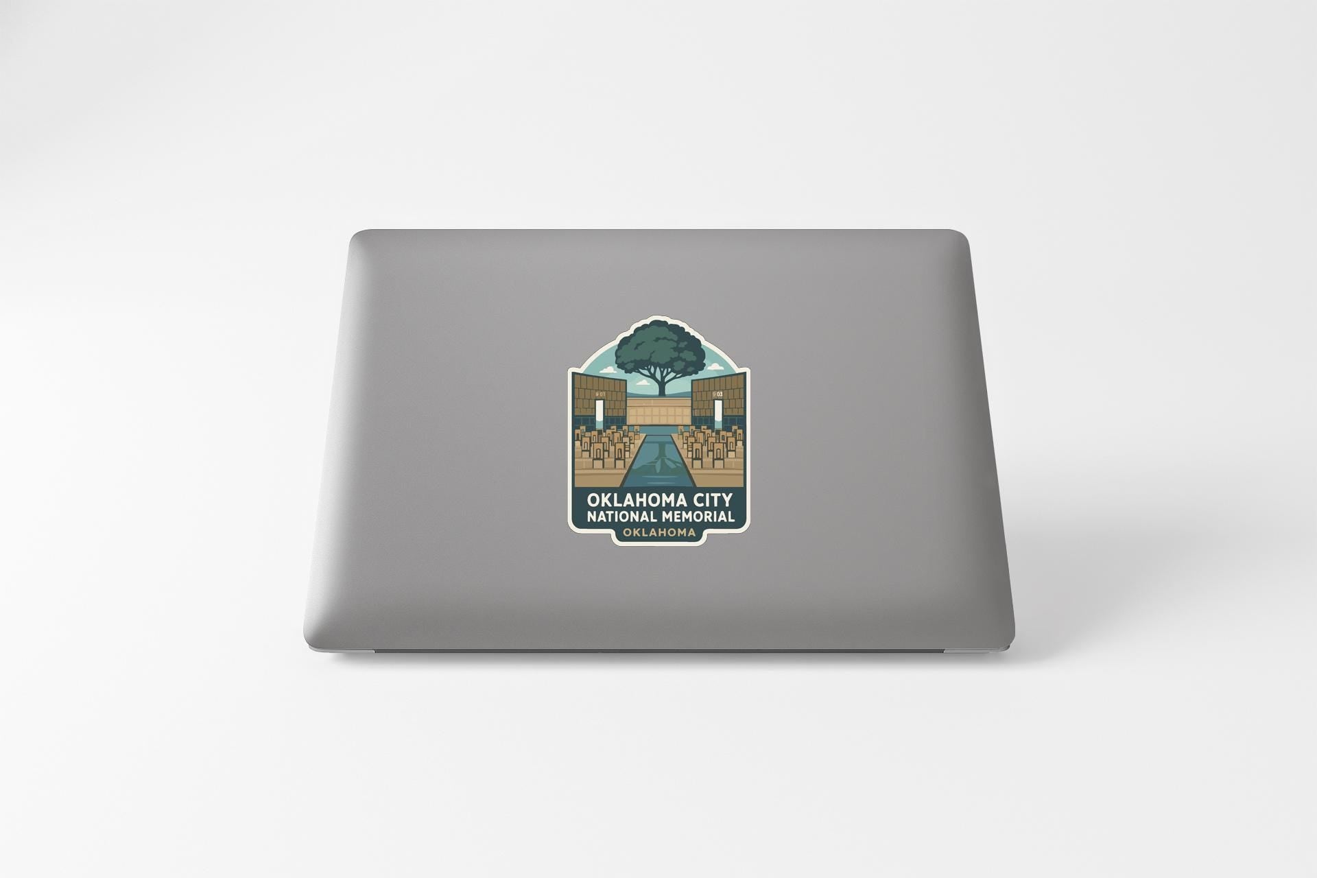 a sticker on the back of a laptop, depicting a scenic view of Oklahoma City National Memorial.