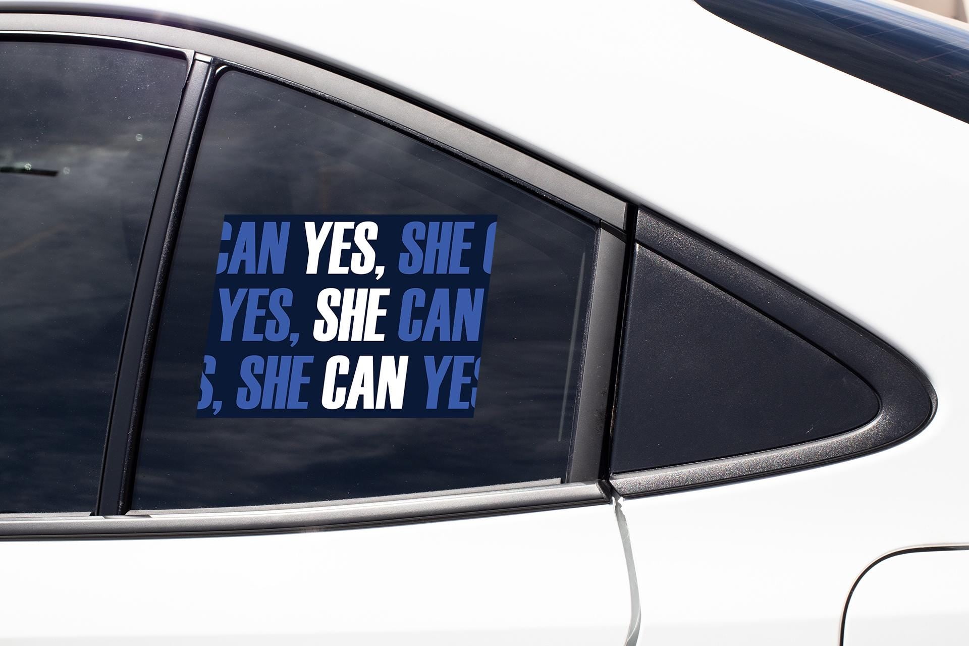 a car with a sticker that says yes, she can and she can '