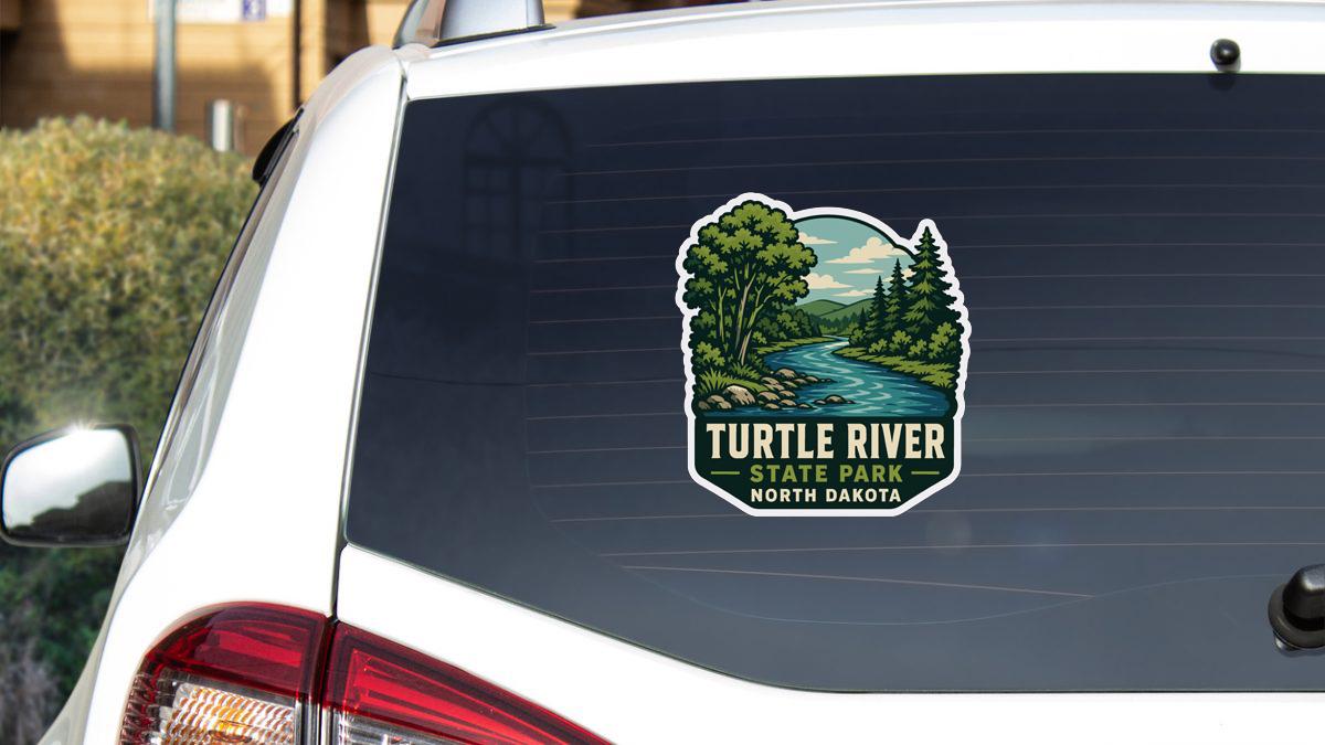 A sticker on the rear window of a white vehicle, depicting a scenic landscape with a river and trees.