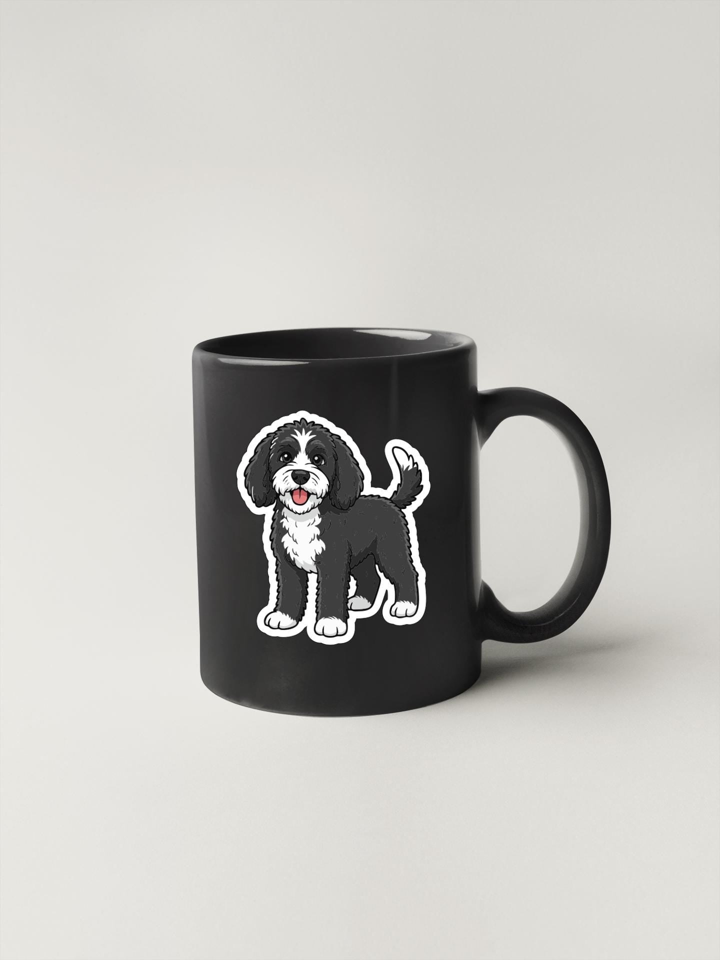 A black mug with a cartoon illustration of a dog on it.