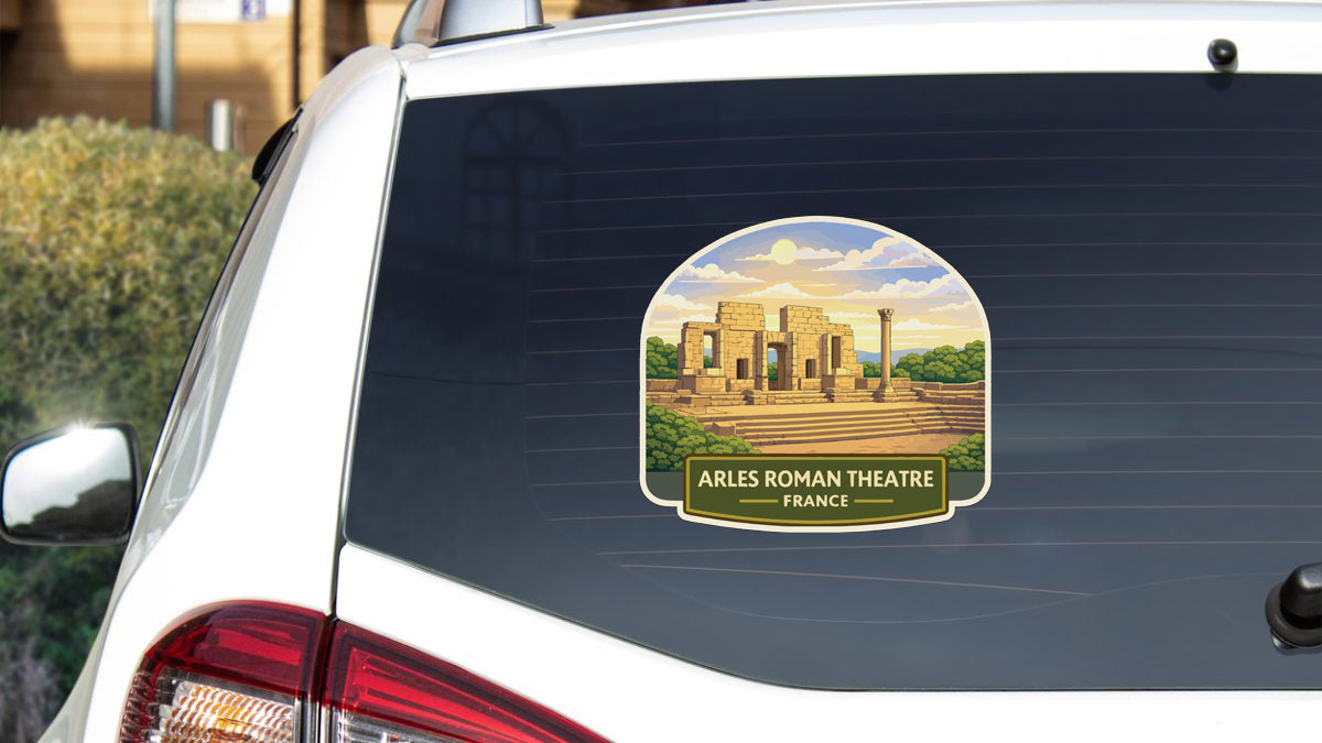 a sticker on the rear window of a car that displays the image of the Arles Roman Theatre in France.