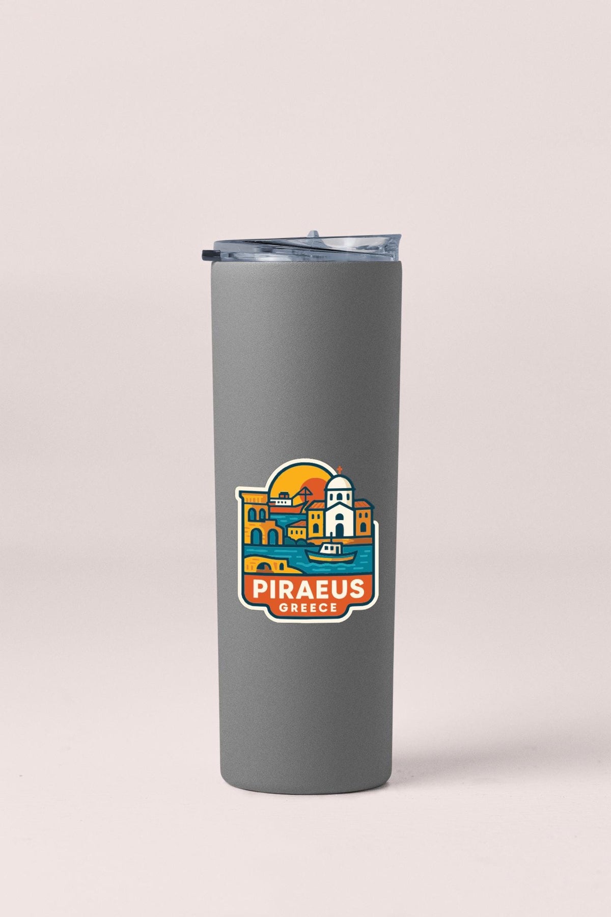 A gray insulated tumbler with a colorful graphic design depicting a cityscape and the text "PIRAEUS GREECE".