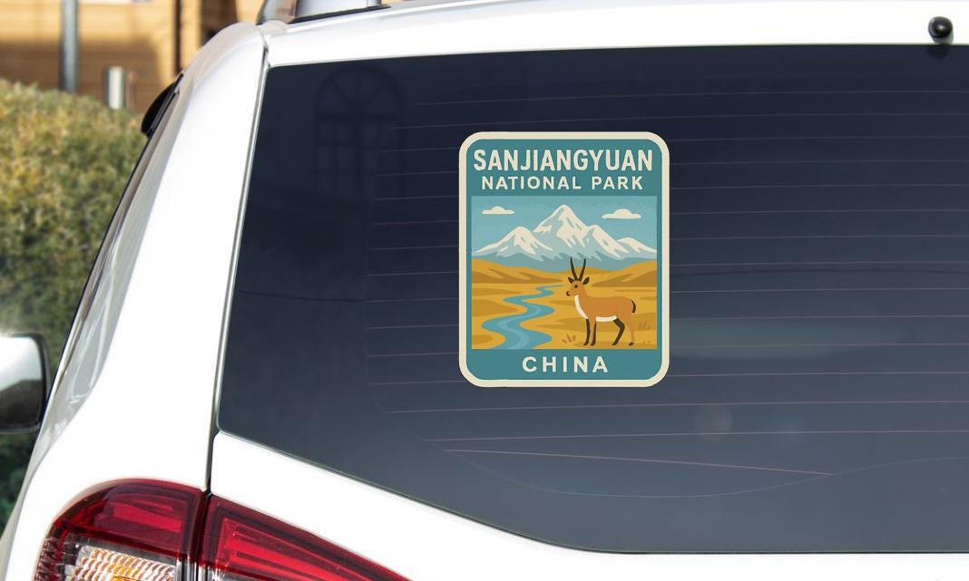 a sticker on the rear window of a car, depicting a national park in China.