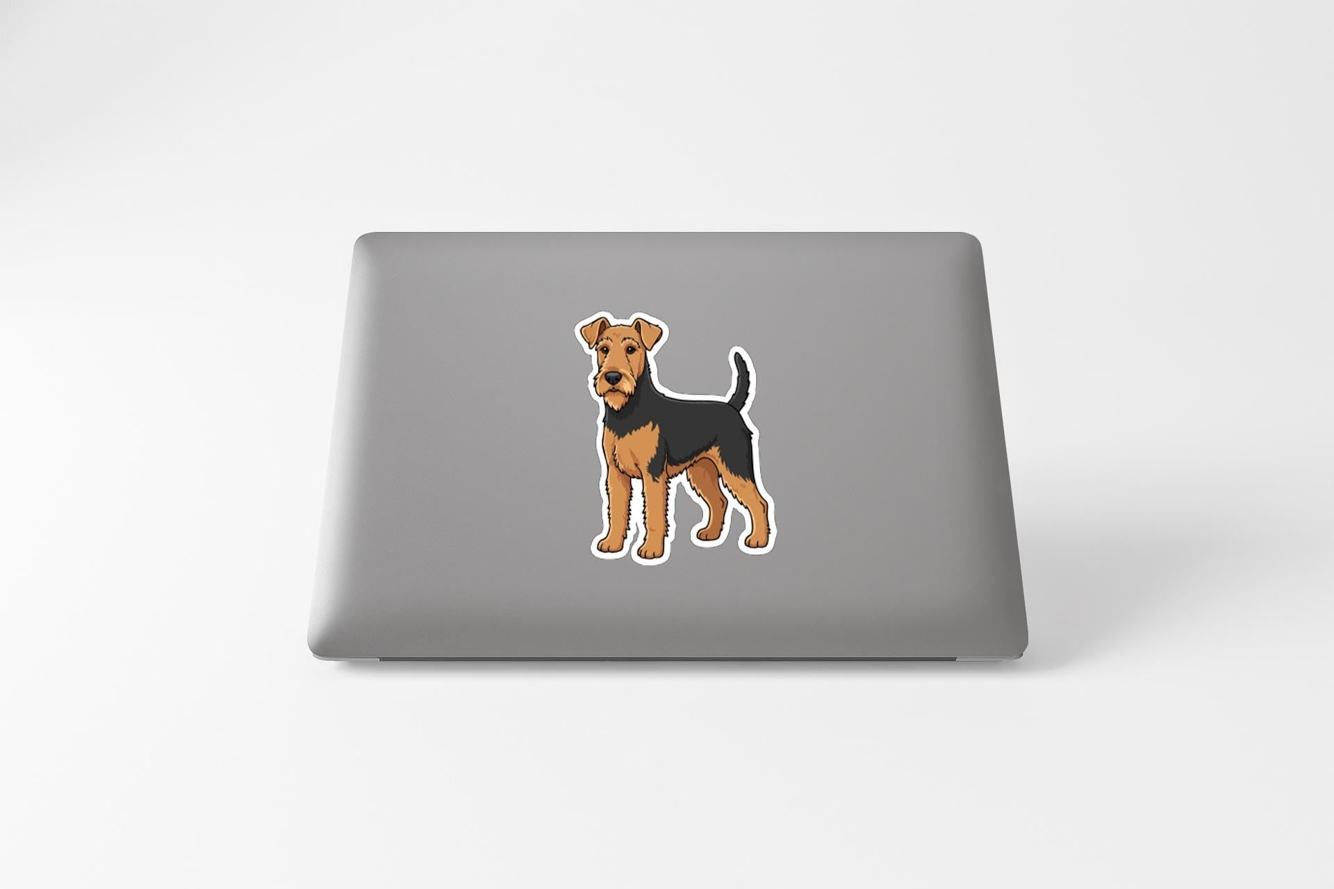 a laptop with a sticker of a dog on its cover.