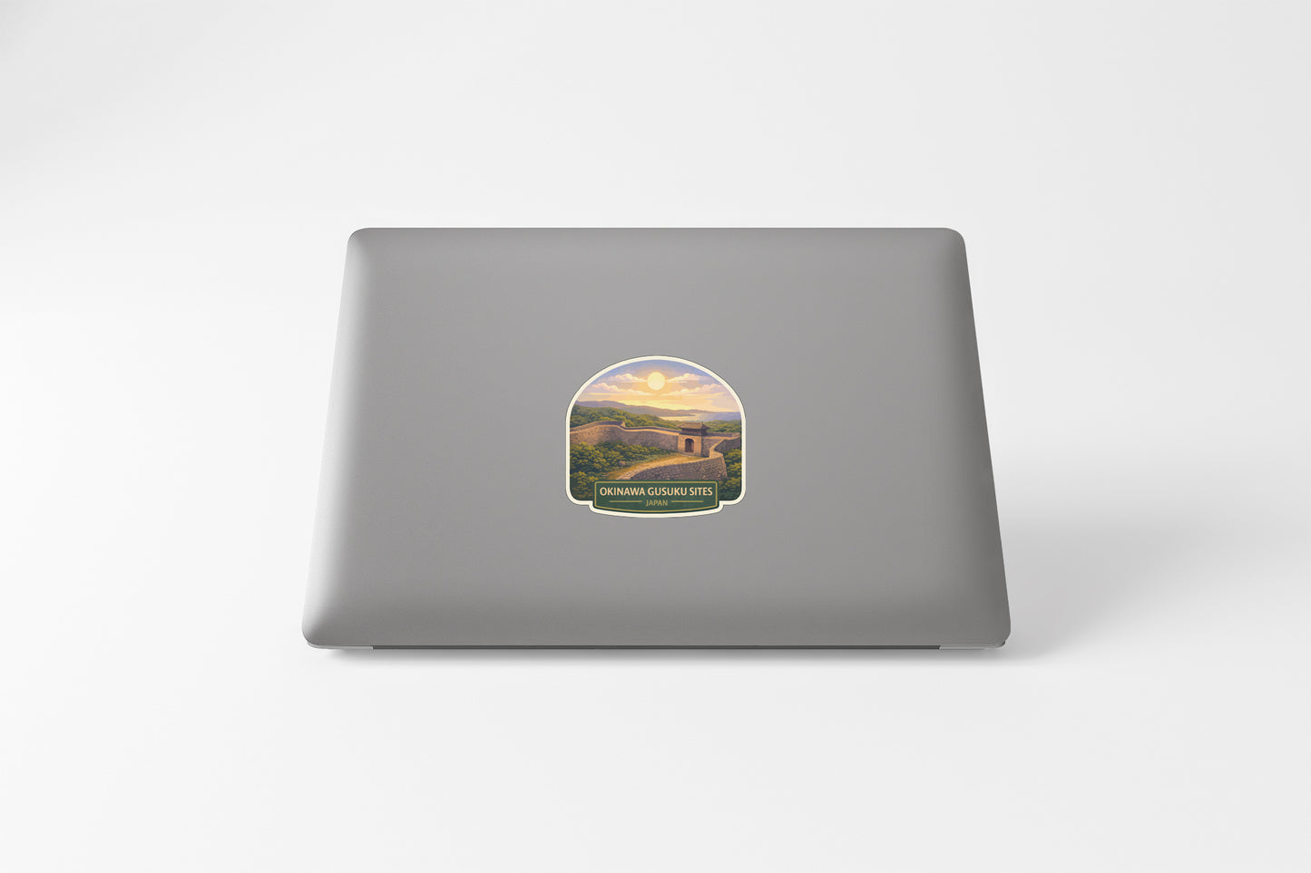 A sticker depicting a scenic landscape with mountains, trees, and a winding road.