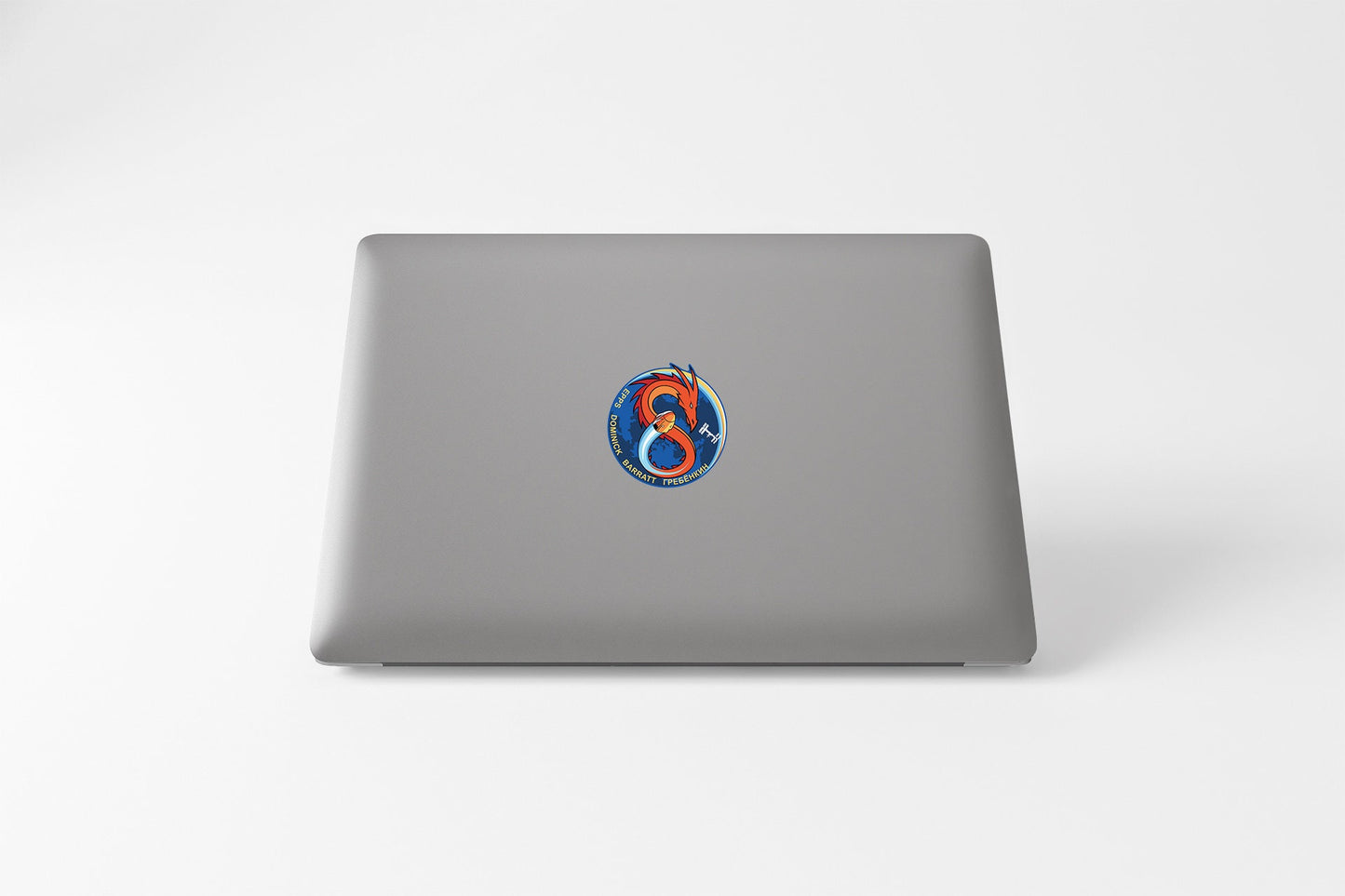 a laptop with a sticker of a bird on it
