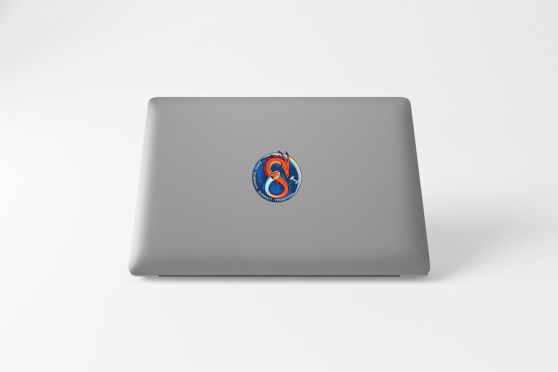 a laptop with a sticker of a bird on it
