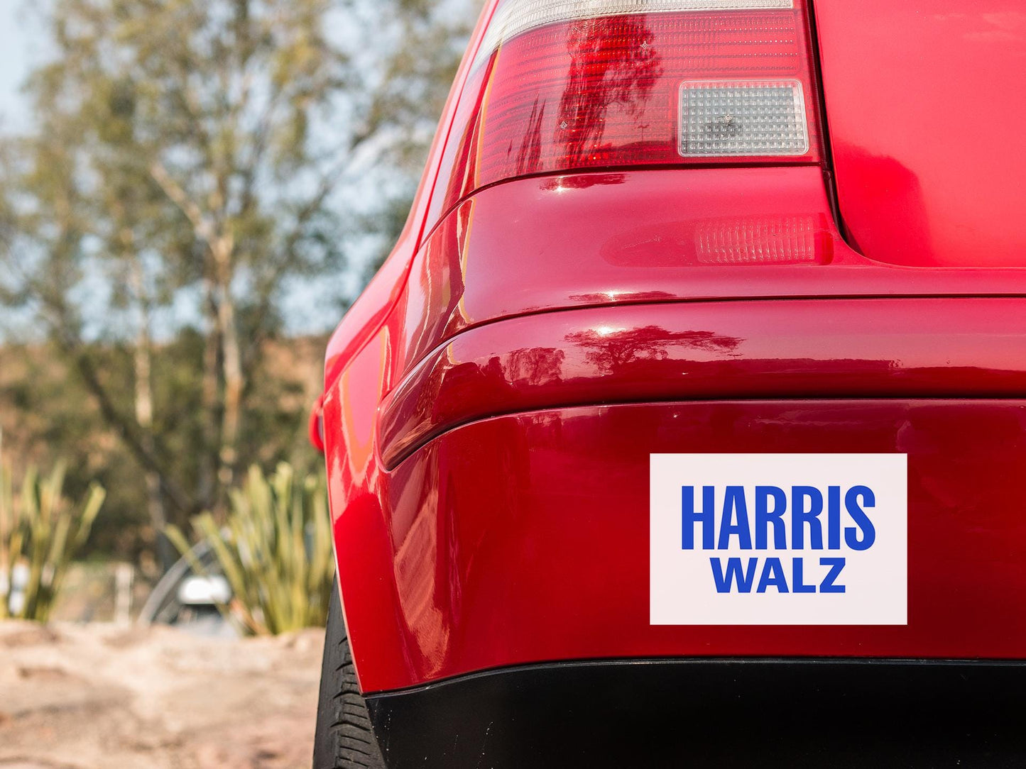 a sticker on the back of a red car