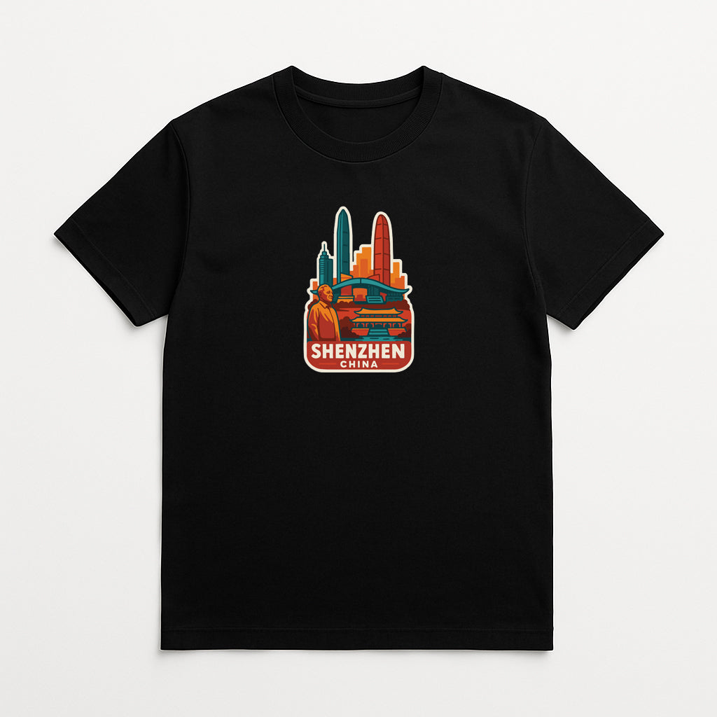 A black t-shirt with a colorful graphic design depicting a city skyline and the text "SHENZHEN" prominently displayed.