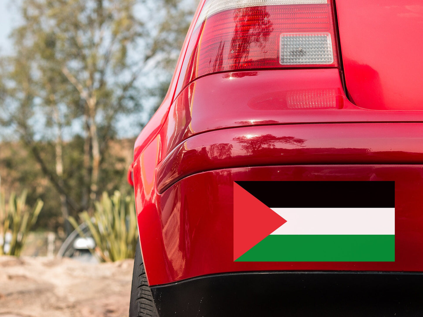 the tail light of a red car with the flag of the united states of jordan