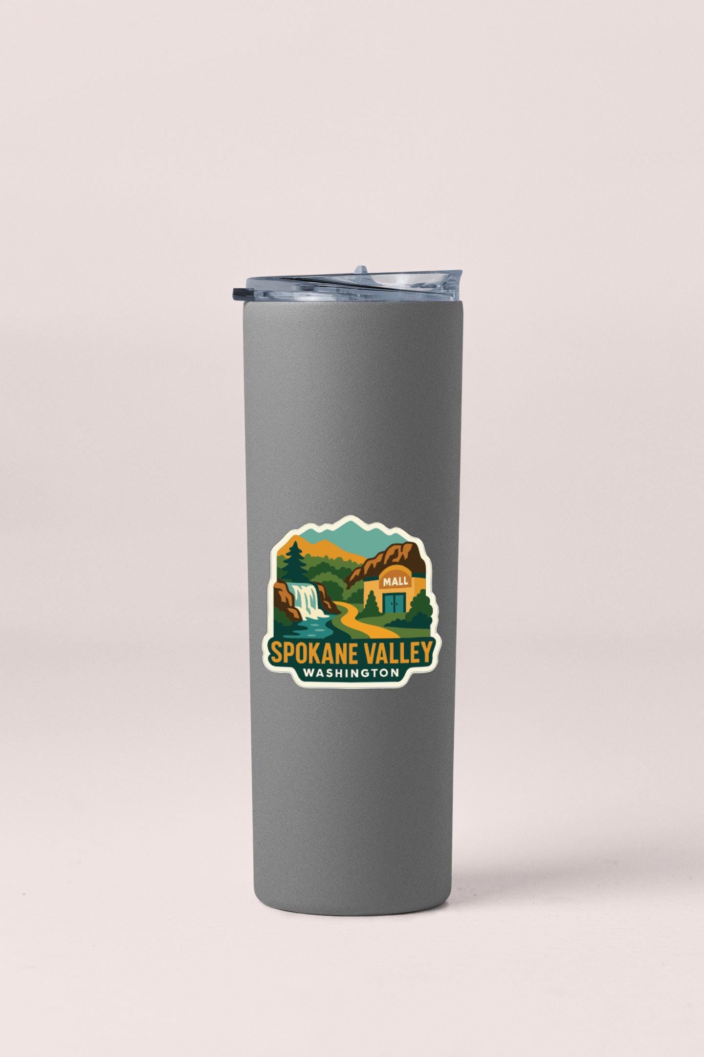 A gray insulated tumbler with a sticker depicting the Spokane Valley in Washington.