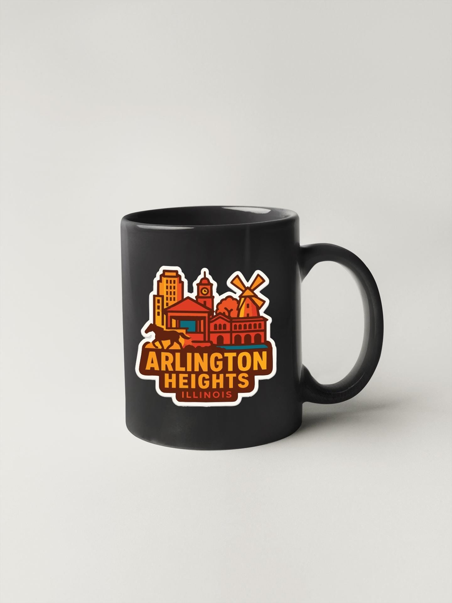 A black coffee mug with a colorful graphic design depicting the skyline of Arlington Heights, Illinois.