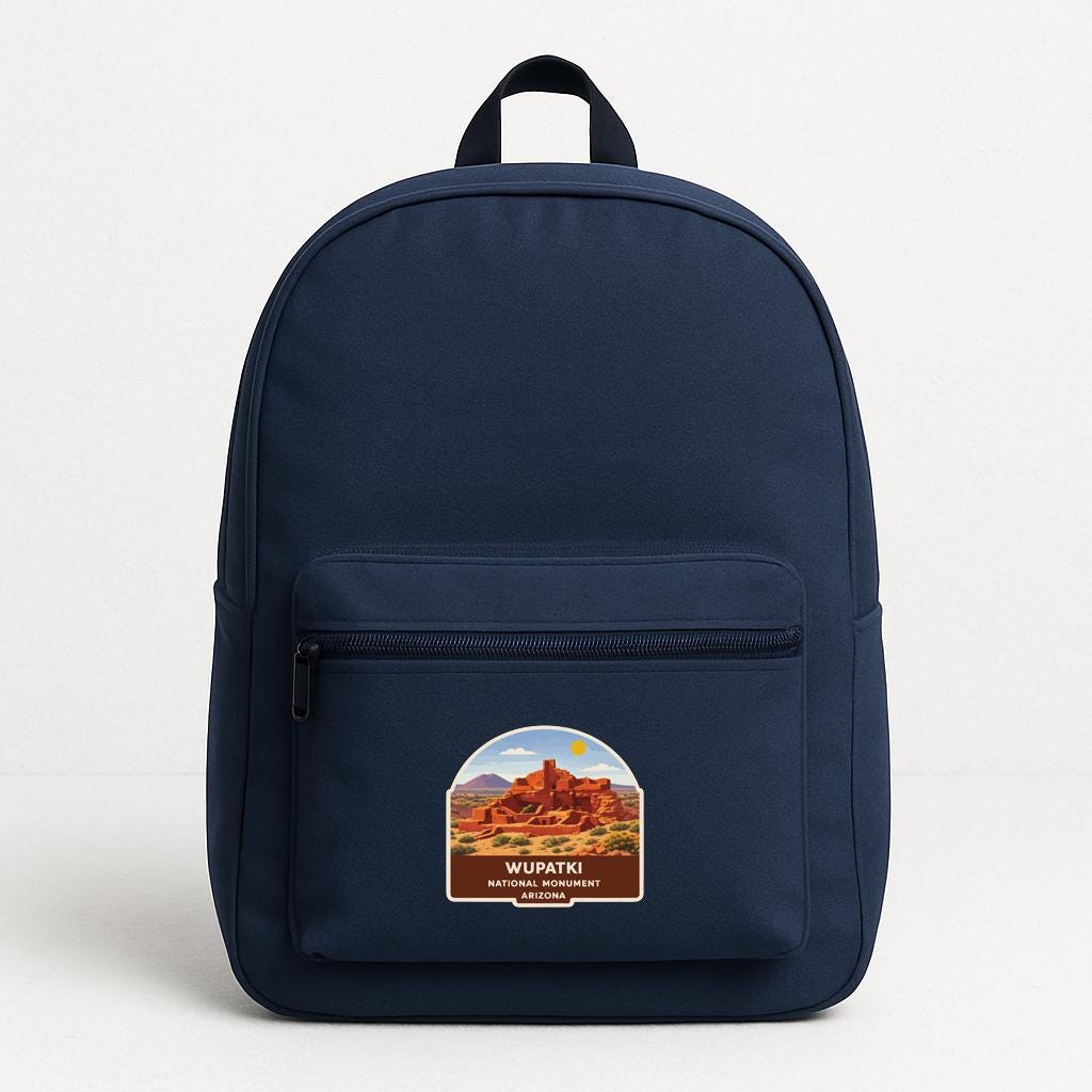 A navy blue backpack with a label that says "WUPATKI" and "ARIZONA" printed on it.