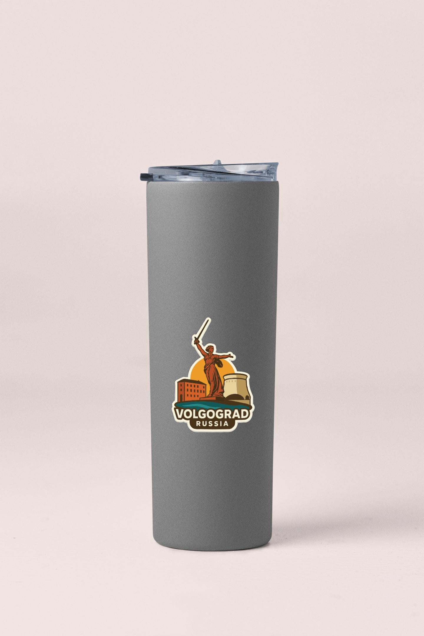 A gray insulated tumbler with a logo featuring a person holding a baton and a building in the background.