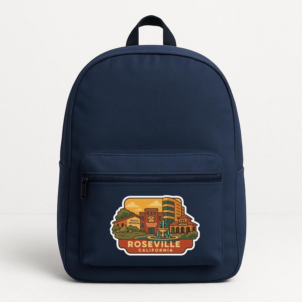 A navy blue backpack with a printed design of a cityscape and the text "ROSEVILLE, CALIFORNIA" on the front pocket.