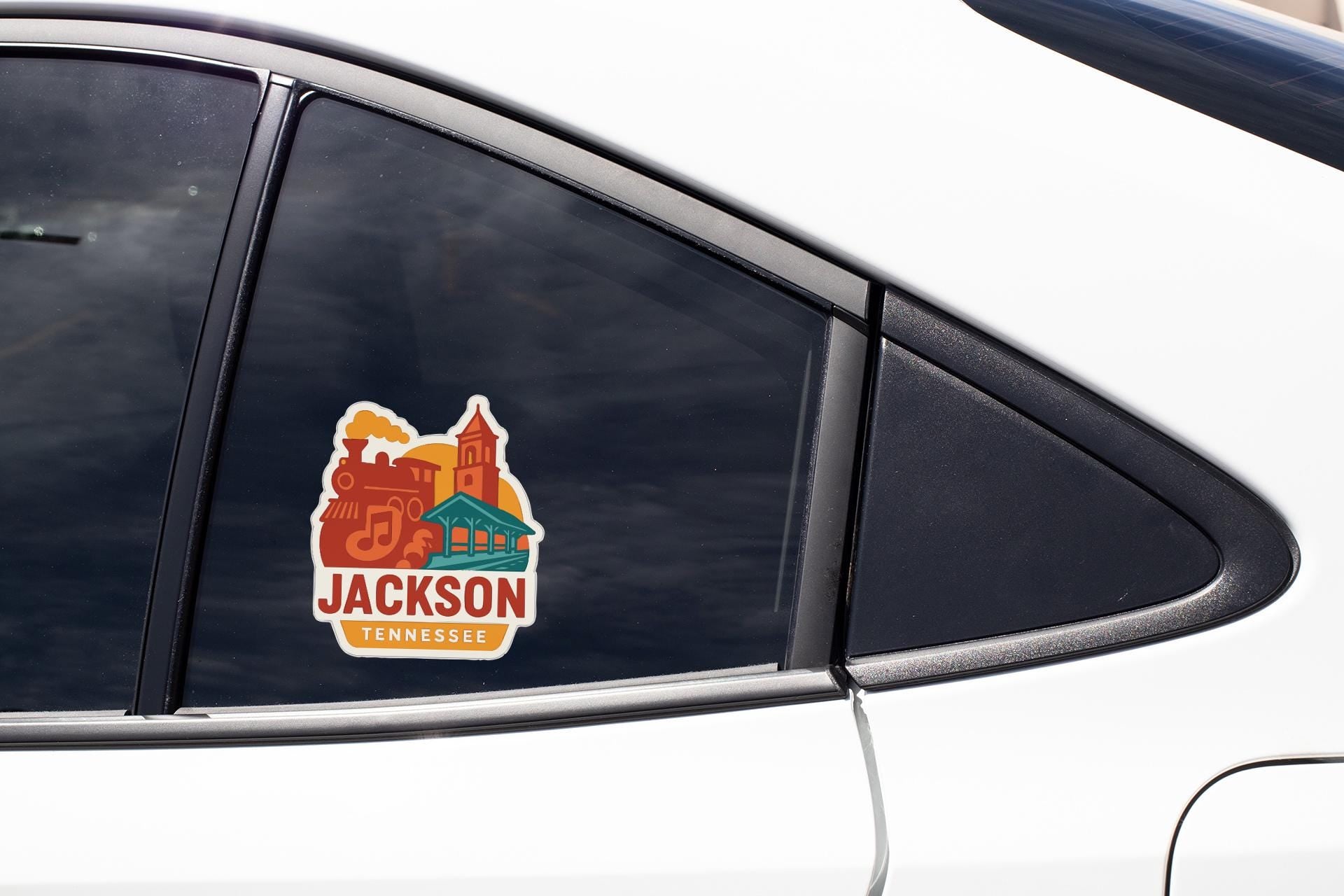 A car window sticker with the text "JACKSON TENNESSEE" and an illustration of a building.