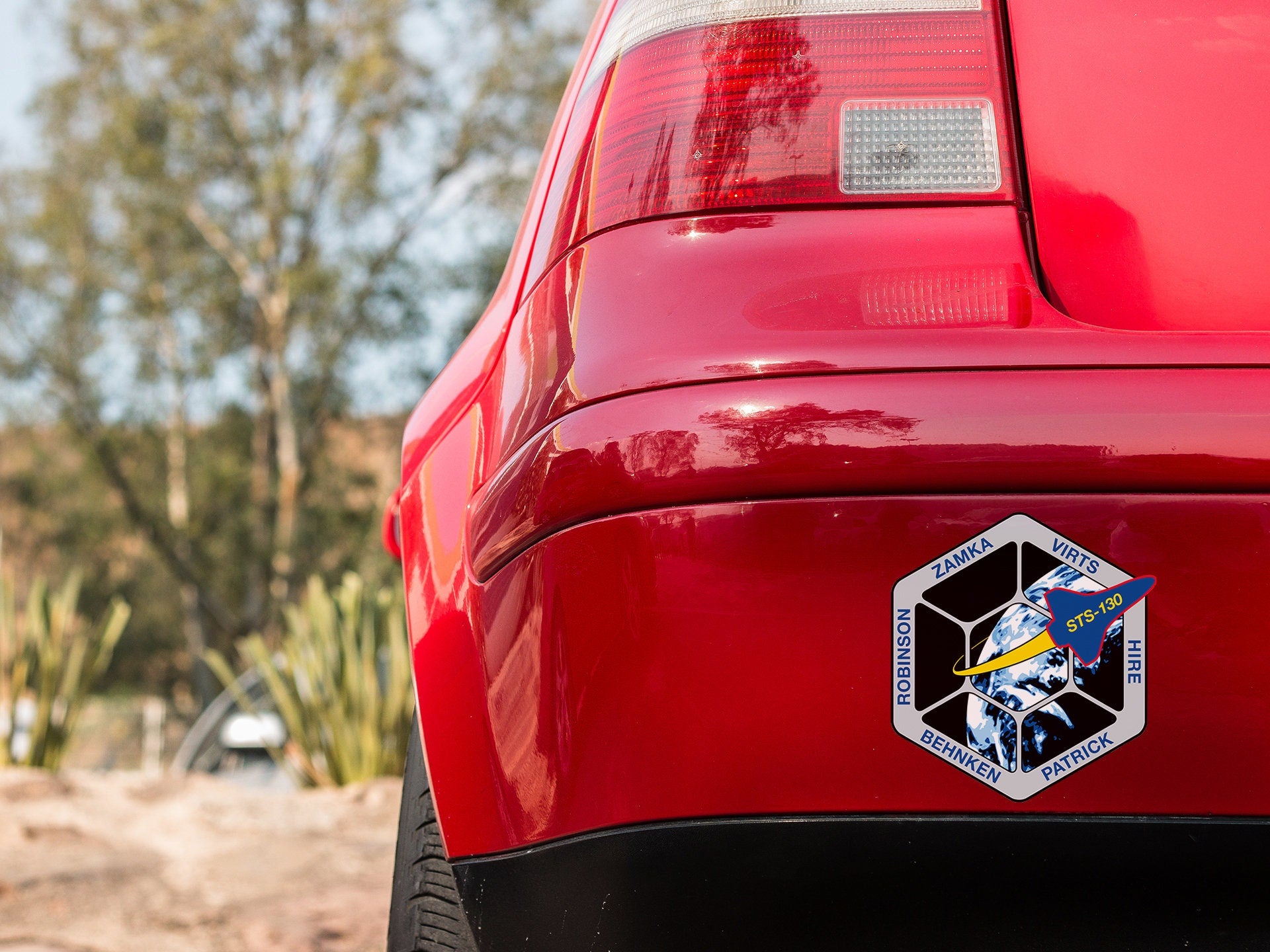 a close up of the rear end of a red car