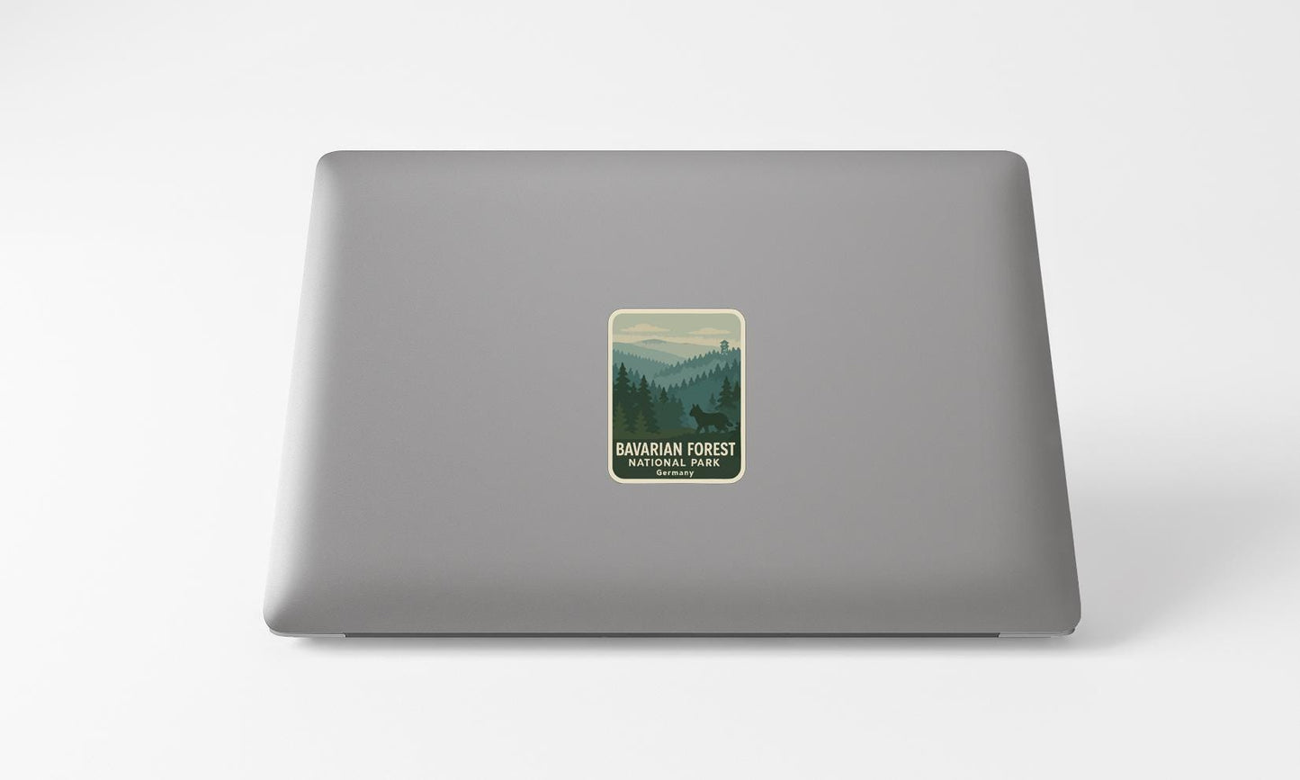 a sticker with a forest scene on a laptop.