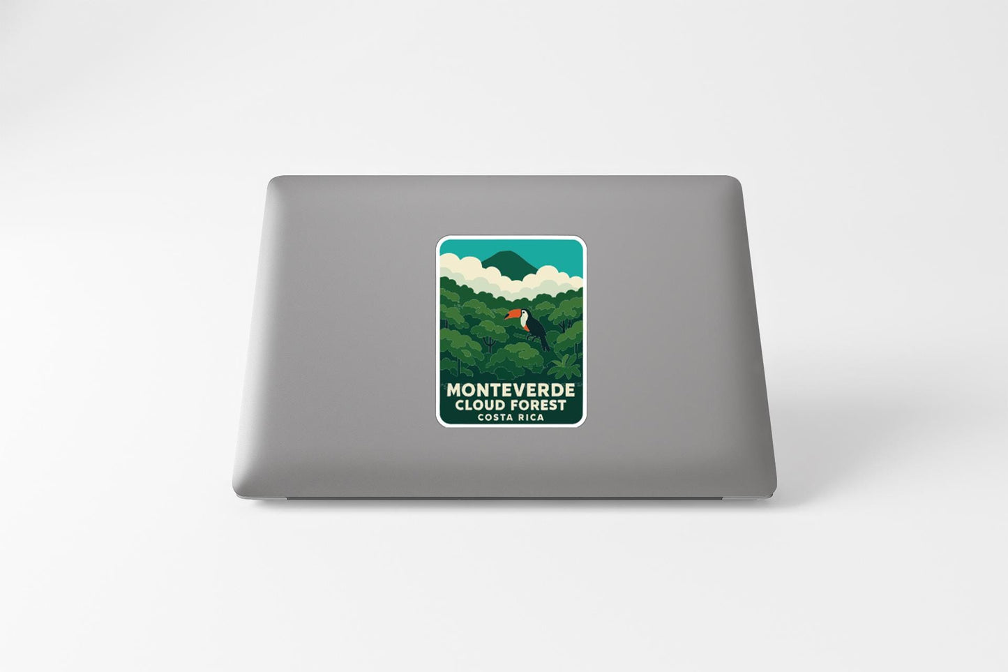 a sticker on the back of a laptop that says "MONTVERDE CLOUD FOREST" and "CERVEZA MEXICO".
