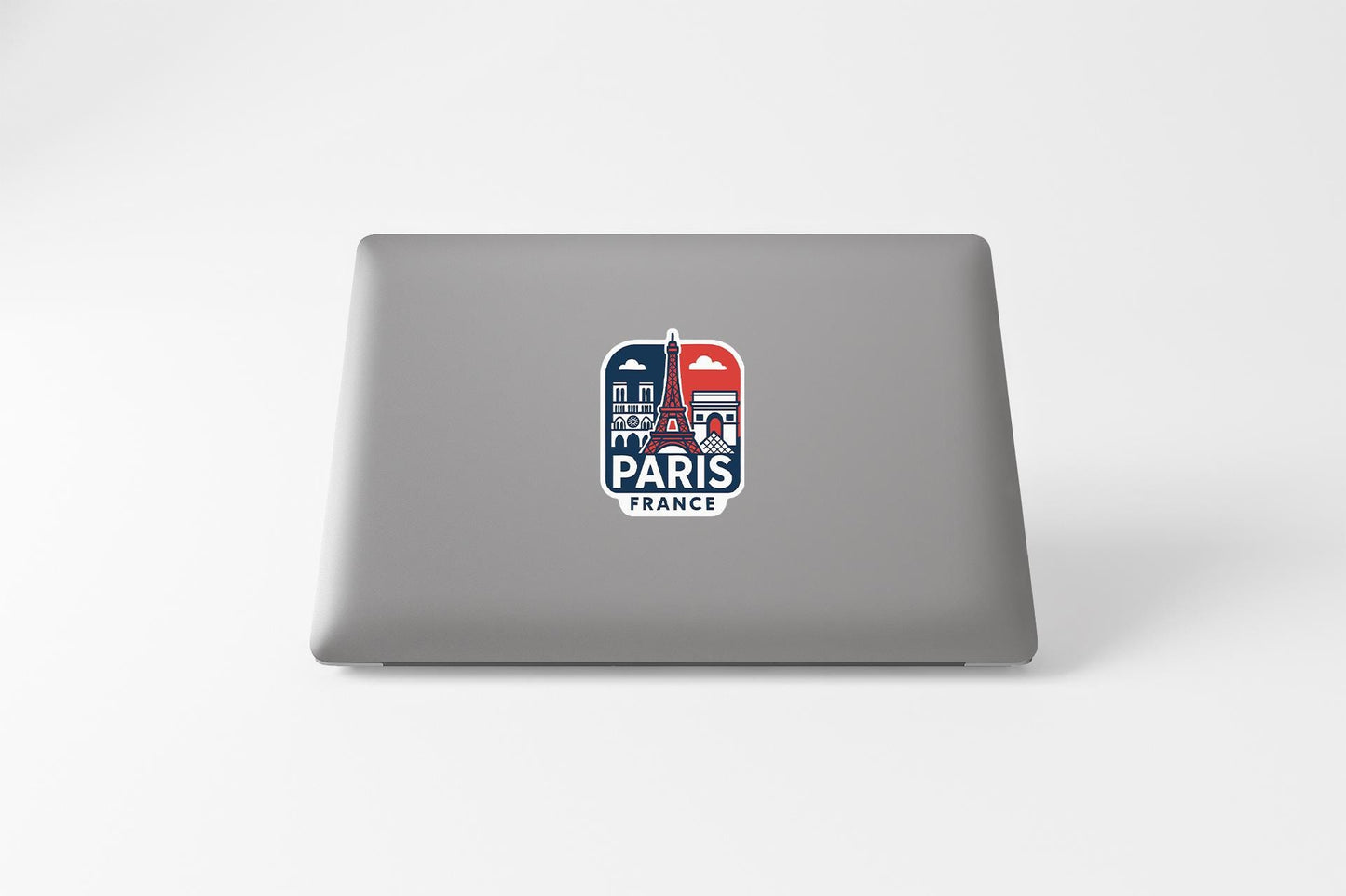 a laptop with a sticker of the eiffel tower in paris