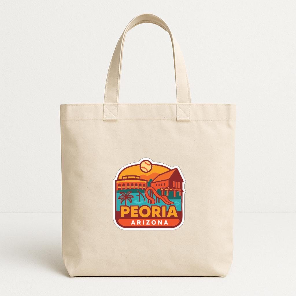 A beige tote bag with a graphic design featuring a beach scene and the text "PEORIA ARIZONA" printed on it.