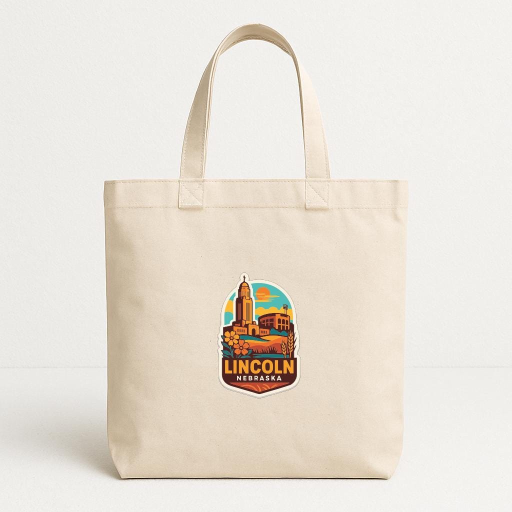 A beige tote bag with a colorful graphic of a city skyline and the text "LINCOLN NEBORSO" printed on it.