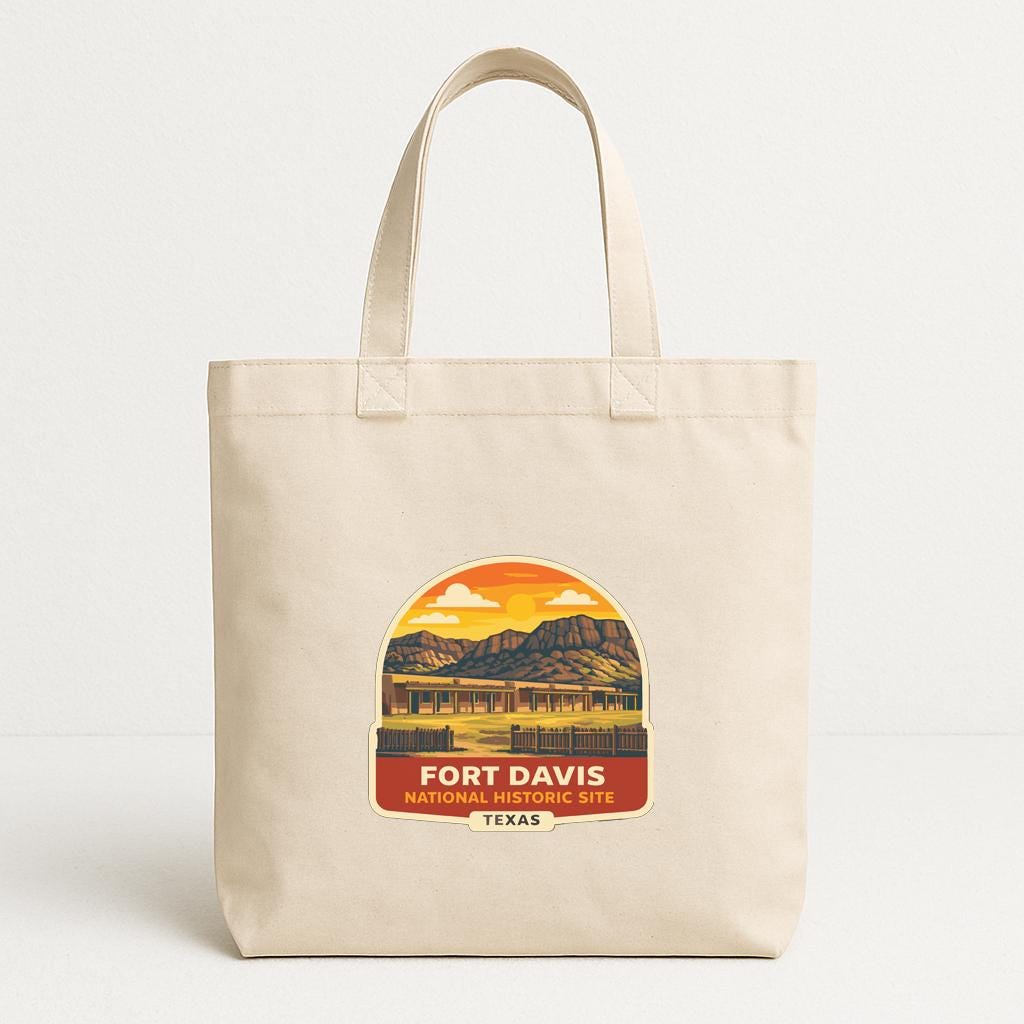 A beige tote bag with a printed design depicting Fort Davis National Historic Site in Texas.