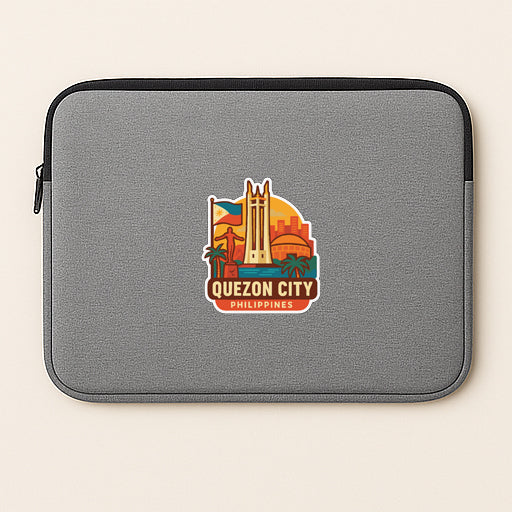 a gray laptop sleeve with a colorful sticker depicting the city of Quezon City, Philippines.