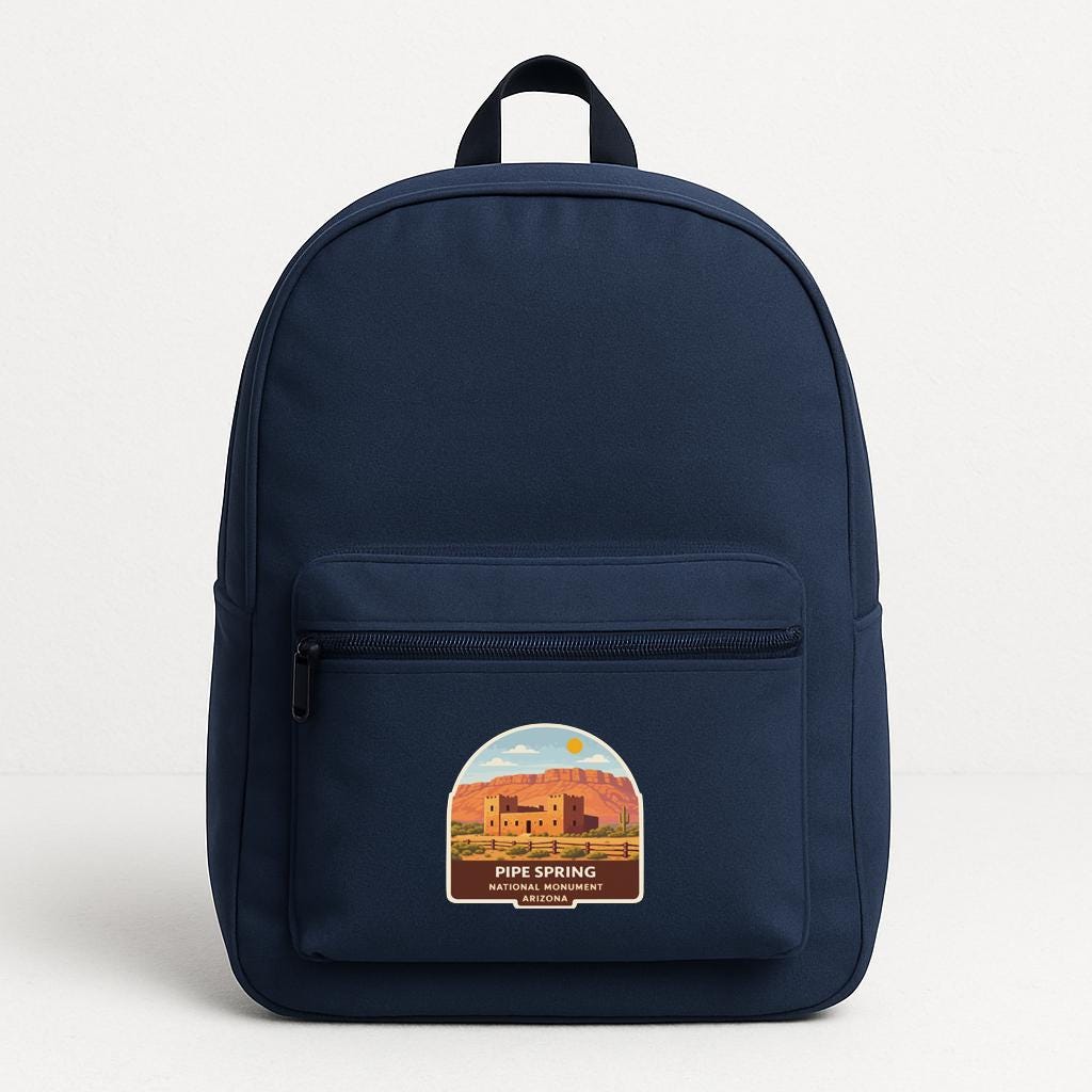 A navy blue backpack with a label that says "PIPE SPRING ARIZONA" on the front pocket area.