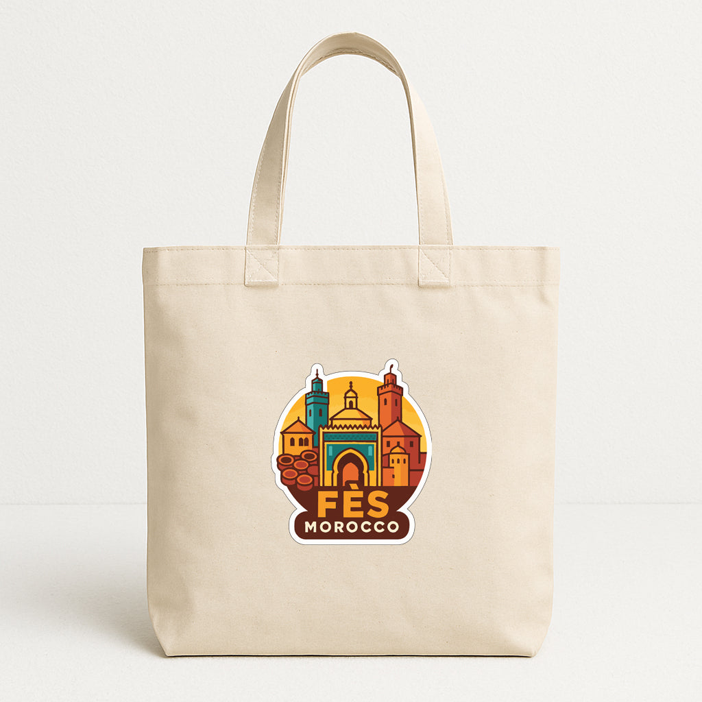 A beige tote bag with a graphic design featuring a colorful illustration of a city skyline and the text "FES MOROCCO" printed on it.