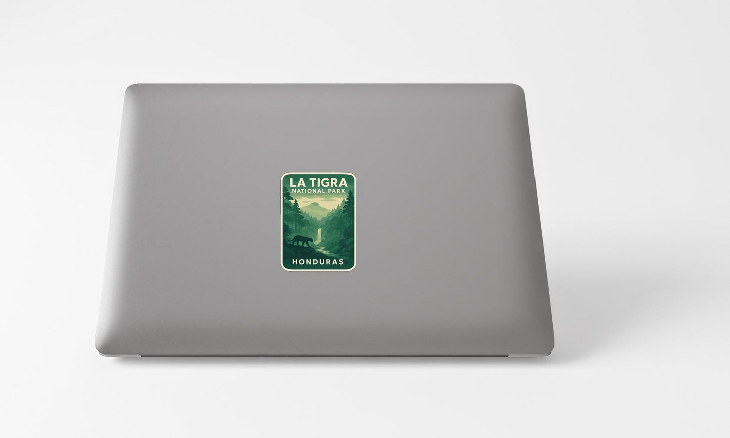 A sticker on the back of a laptop, depicting a forest scene with mountains in the background.