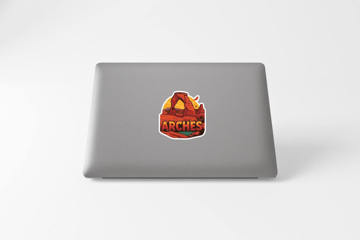 a sticker with the word "ARCHES" on a laptop.