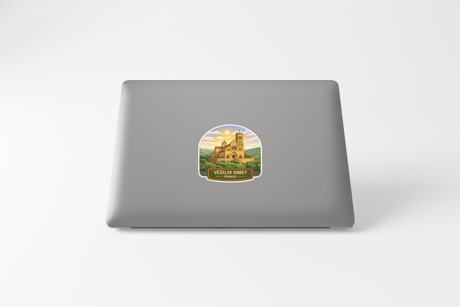 a sticker with a castle on it, placed on the back of a laptop.